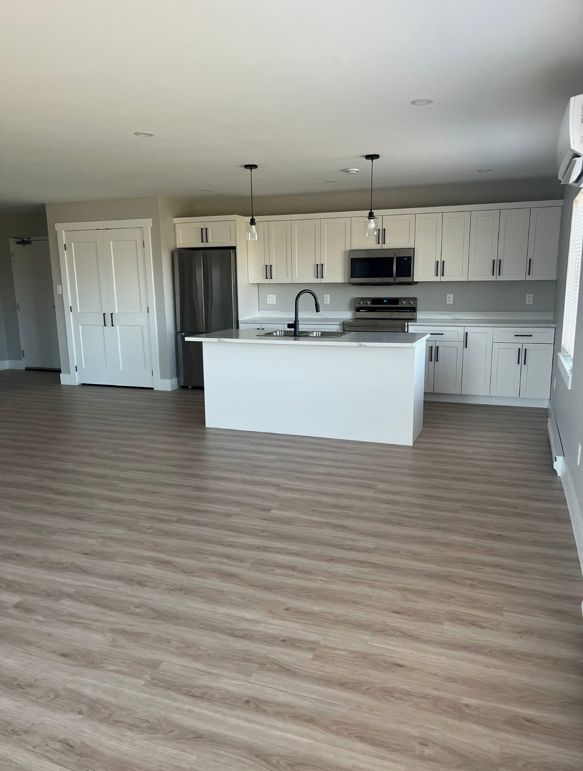 Kitchen with island in a 204 Bellevue Heights unit